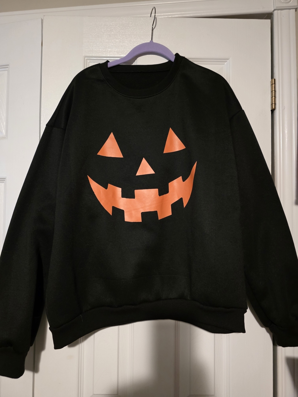 Black Crewneck Sweatshirt with Orange Jack-O'-Lantern Graphic